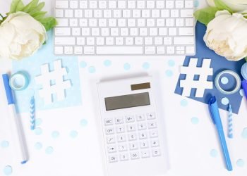 white and black calculator on white and blue textile